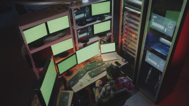 Hacker-using-computer-with-multiple-monitors