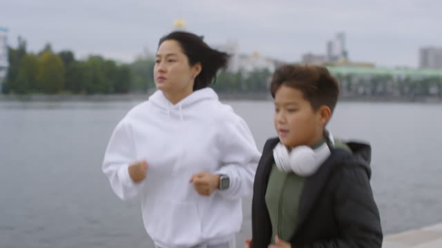 Asian-Woman-Jogging-with-Young-Son