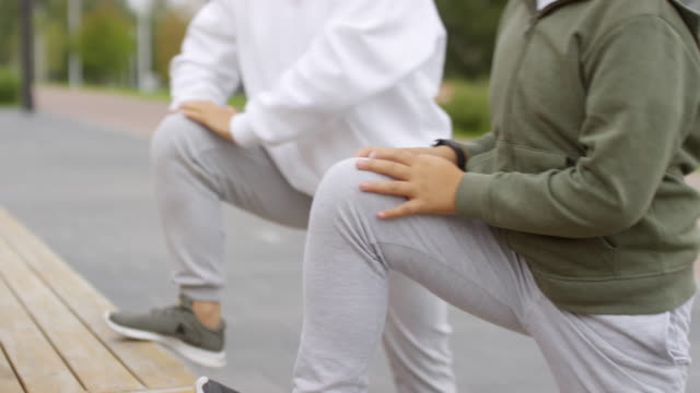 Asiatischer-Junge-und-seine-Mutter-tun-Stretching-Übung-im-Freien