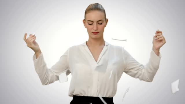 Angry-young-woman-rips-paper-documents,-throw-it-at-the-camera-on-white-background