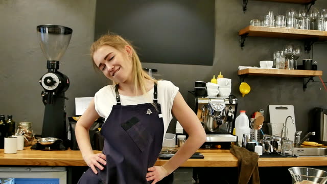 Barista-dancing-and-laughing-at-work-in-a-cafe