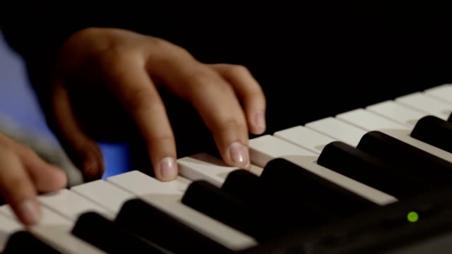 Male-hands-plays-piano