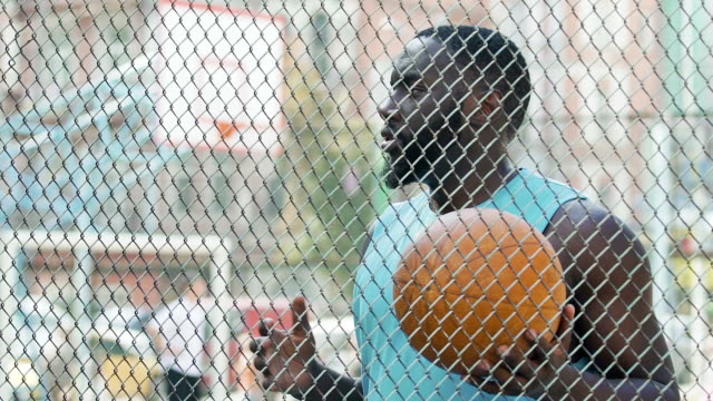 Basketball-coach-eagerly-waiting-for-team-at-sports-ground,-outdoor-training
