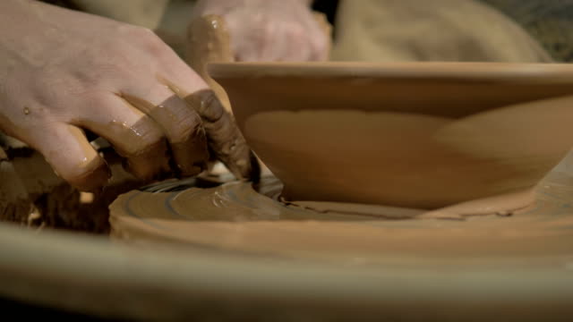 Male-potters-hands-making-a-bowl-on-a-wheel.