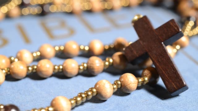 wooden-rosary-on-the-bible