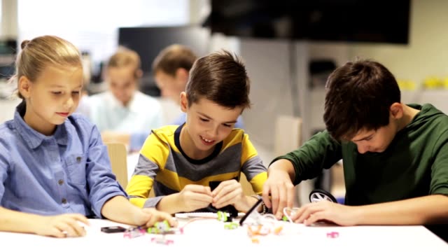 group-of-kids-learning-to-create-robots-at-robotics-school-lesson