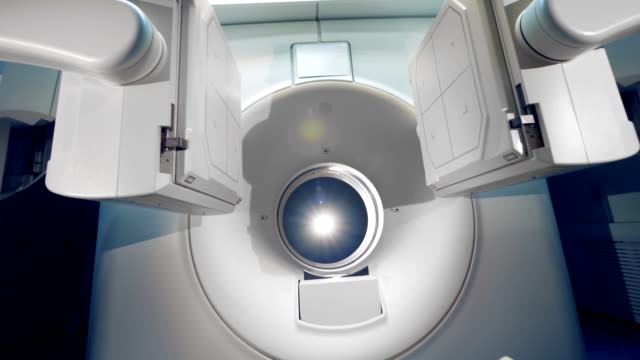 New-medical-equipment-in-action.-White-tomographic-scanner-in-a-modern-hospital.