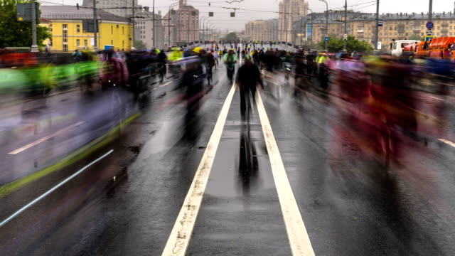 parade-of-bicyclists,-bike-riders--despite-the-bad-weather,-time-lapse