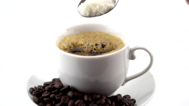 Pouring-sugar-into-black-coffee