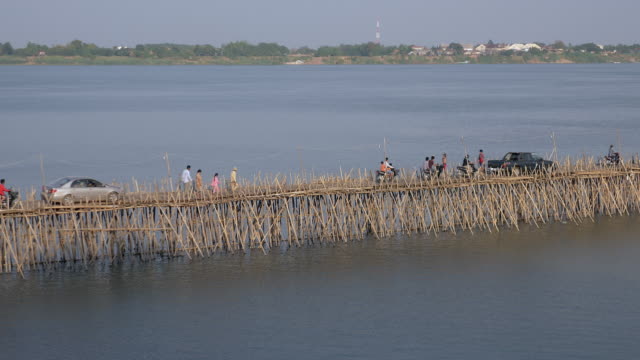 Traffic-jam-on-the-bamboo-bridge;-motorbikes,-cars,-and-people-on-foot-crossing-it-(-time-lapse)