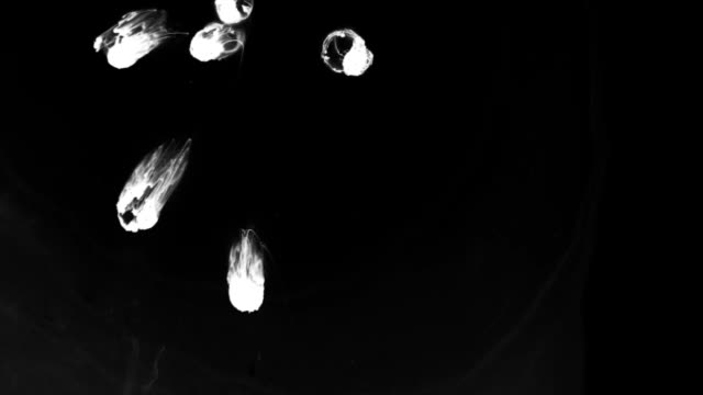 White-drops-ink-dropped-in-black-water.-Top-view.