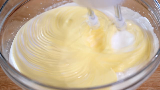 Whipping-cream-with-electric-mixer.-Home-bakery.-Ingredients-for-baking-at-home.-Beating-eggs-with-hand-mixer.