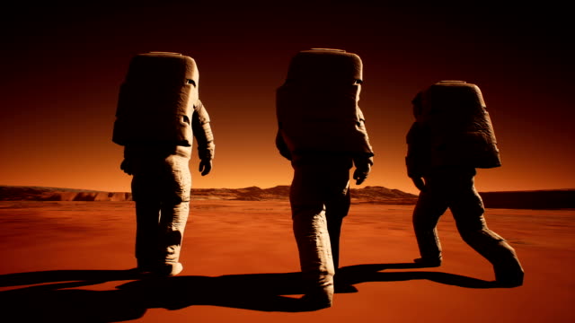 Three-astronauts-in-spacesuits-confidently-walk-on-Mars-in-search-of-life