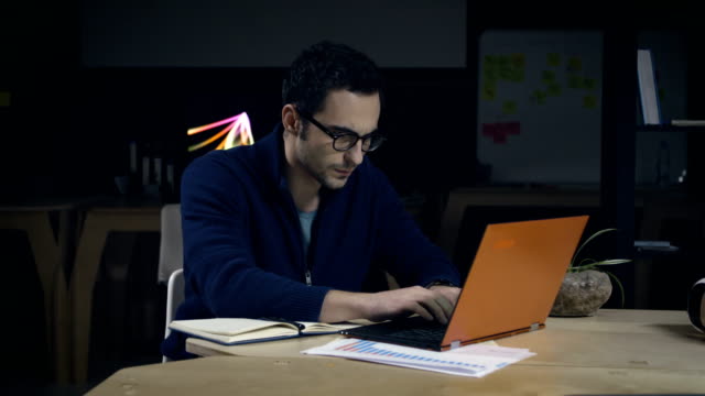 Creative-man-in-glasses-working-late-at-night