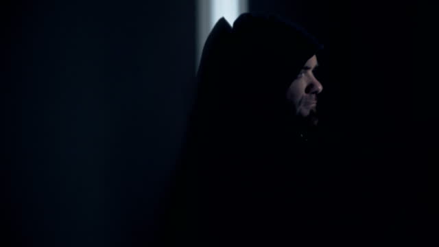 Portrait-of--depressed-hooded-man-in-the-darkness