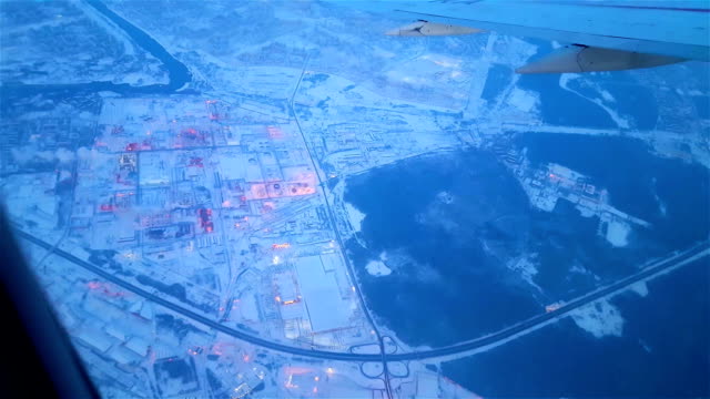 Airplane-flying-over-snowy-suburb-in-the-early-morning-FullHD