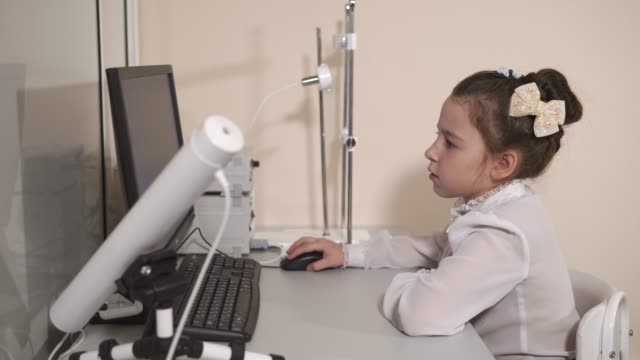 Cute-pupil-sitting-at-computer