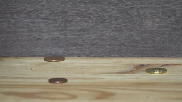 Business-concept---man-hand-collect-euro-coins-on-the-wooden-table.