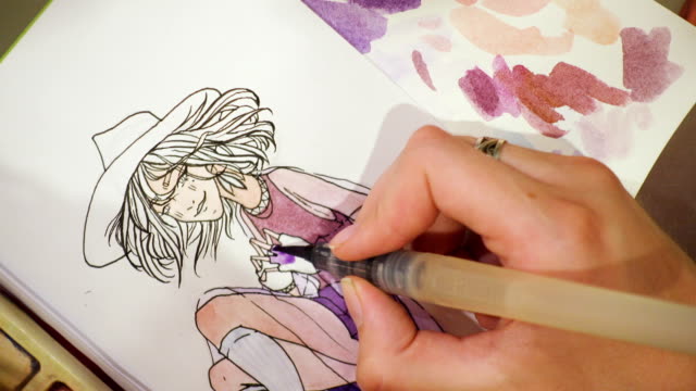 artist-drawing-a-sketch-with-the-watercolors-paints