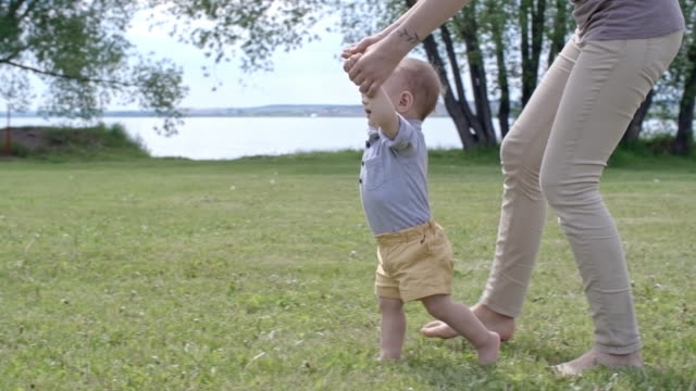 Mother-Helping-Toddler-Taking-First-Steps