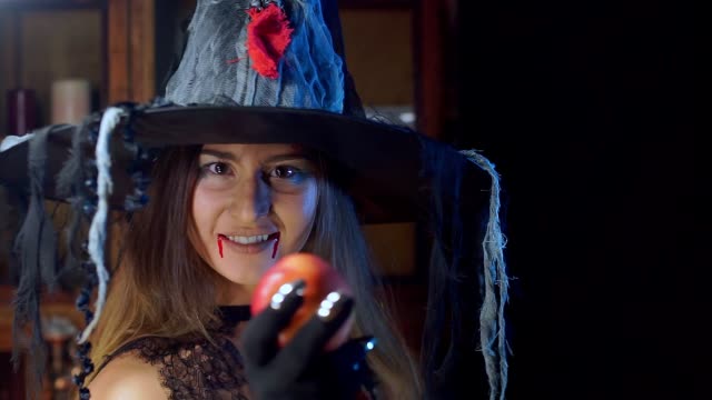 Halloween-witch-close-up-in-a-hat.-Turns-to-the-camera-and-smiles