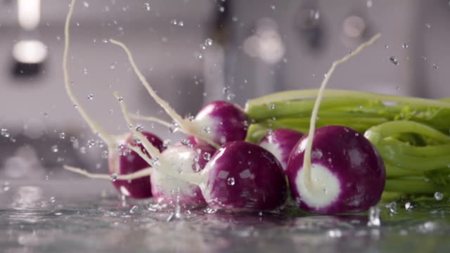 Falling-of-radish-into-the-wet-table.-Slow-motion-480-fps