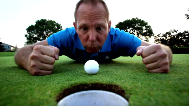 Golfista-está-molesto-de-que-no-va-su-bola-en-el-agujero.-Tiro-de-cerca.