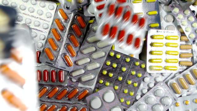 A-lot-of-colored-pills-or-drugs-background.-Many-medication-on-the-table.-First-aid-kit-with-pills.-Pharmacy-with-medicine.