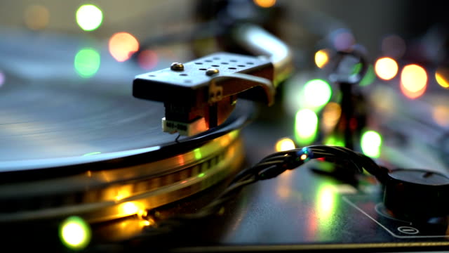 festive-mood-holidays-concept-old-style-vinyl-tape-recorder-spinning-plate-shining-bokeh-color-lights