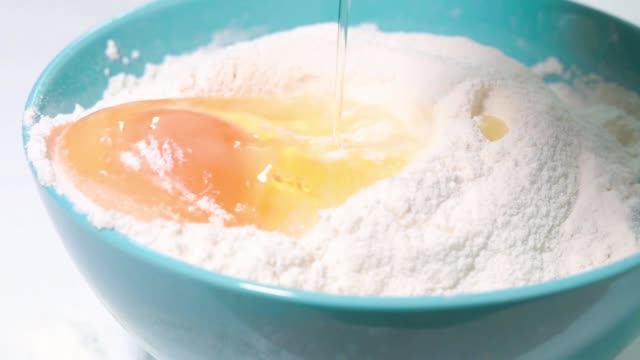 Egg-falls-into-flour-slow-motion-shot