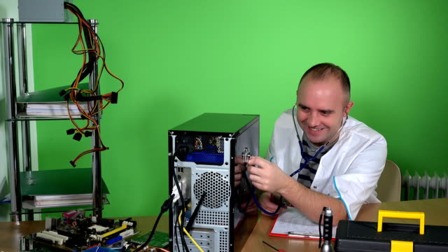 Mad-man-pc-doctor-examining-computer-case-with-stethoscope-and-laughing
