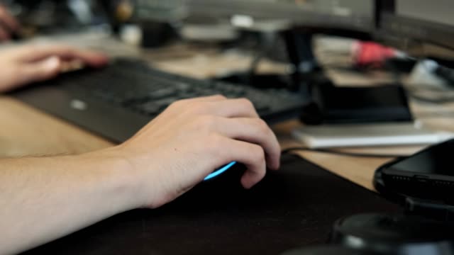 Close-up-of-man's-hand-working-at-computer.-Male-uses-computer-mouse-for-work