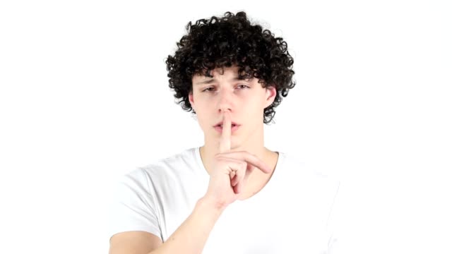 Silence,-Young-Man-with-Curly-Hairs,-white-Background,--Finger-on-Lips