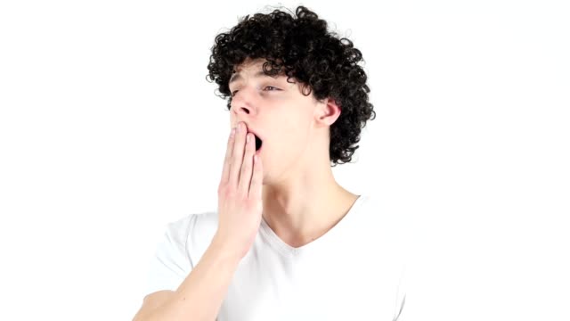 Yawning-Tired-Young-Man-with-Curly-Hairs,-white-Background