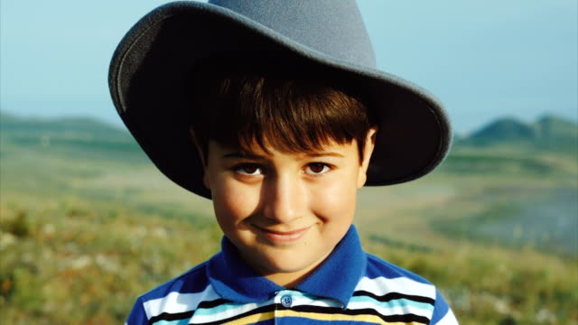 Portrait-of-a-smiling-boy-in-a-felt-hat