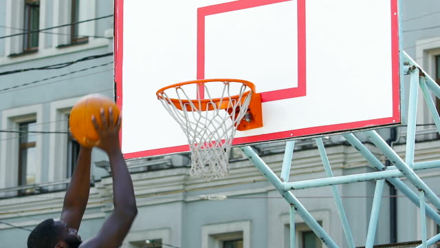 Black-streetball-player-bringing-extra-points-for-team,-winning-sports-match