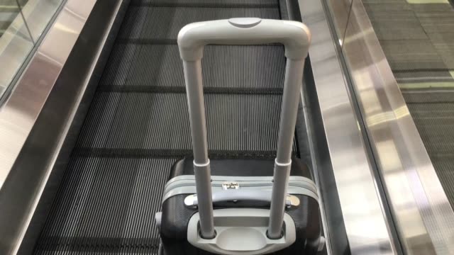 Travel-bag-on-travelator-or-slide-way-in-airplane