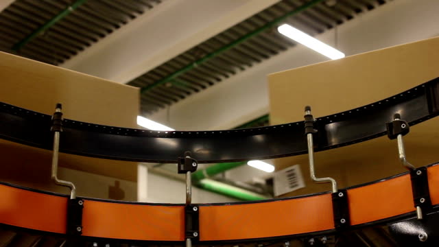 Cardboard-boxes-On-Conveyor-Belt-In-Distribution-Warehouse