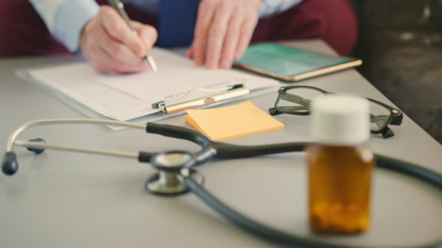Healthcare-Worker-Writing-RX-Prescription-By-Digital-Tablet-4K