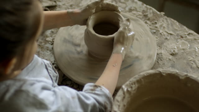 Little-Girl-Making-Pottery-on-Spinning-Wheel