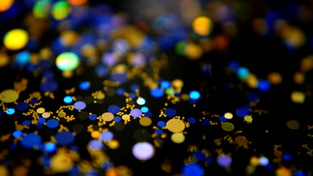 Defocused-shimmering-multicolored-glitter-confetti,-black-background.-Party,-magic,-imagination.-Rainbow-colors,-sparkle-circles.-Holiday-abstract-festive-texture-of-shiny-blurred-bokeh-light-spots.