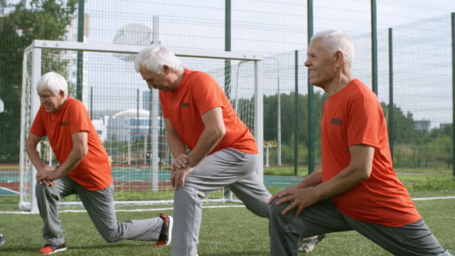Seniors-Warming-Up-before-Playing-Football