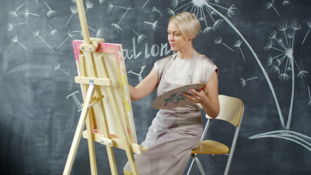 Female-Artist-Creating-Painting-in-Art-Studio