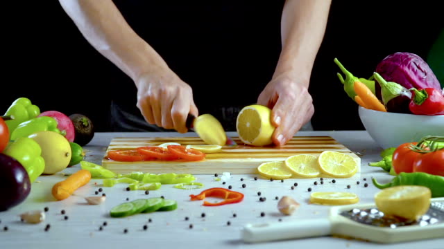 Man-is-cutting-lemon-in-the-kitchen