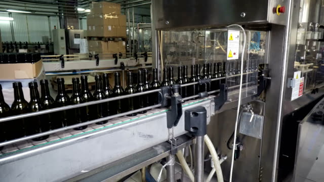 Bottling-and-sealing-conveyor-line-at-winery-factory