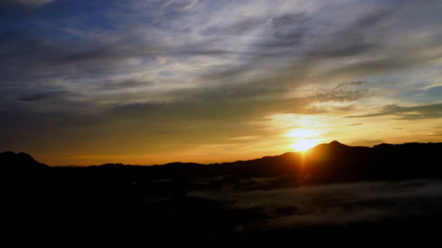 Zeitraffer-des-Sonnenaufgangs-im-Morgengrauen-mit-Berg--und-nebligen-Landschaft
