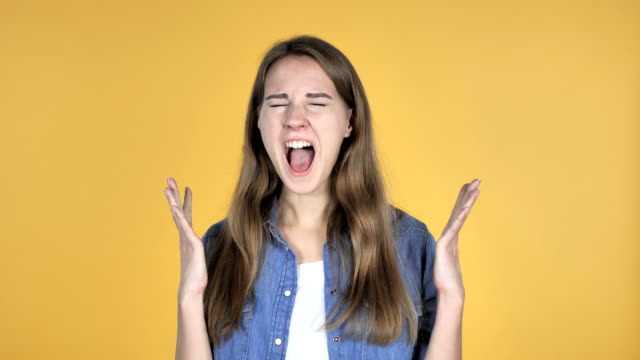 Screaming-Angry-Pretty-Woman-Isolated-on-Yellow-Background
