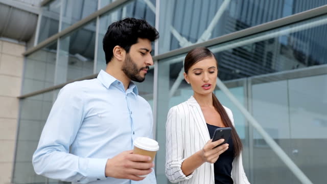 Business-People-Going-To-Work-With-Phone-And-Coffee-On-Street