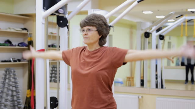 Senior-woman-doing-exercises-in-fitness-room.