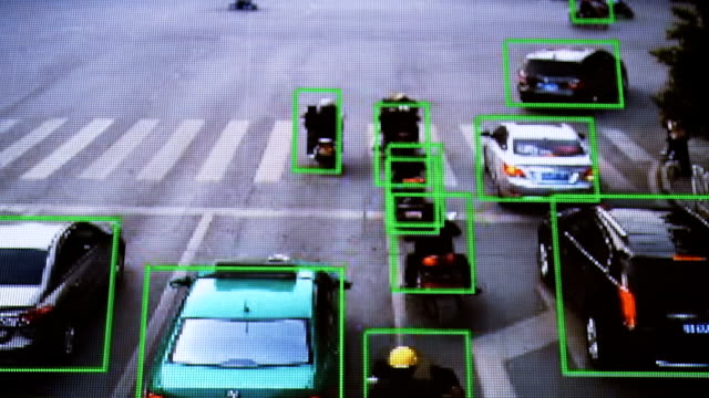 CCTV-camera.-Real-time-tracking-of-vehicles-and-people-on-the-street.-Authentic-pixelated-image-from-a-real-monitor.